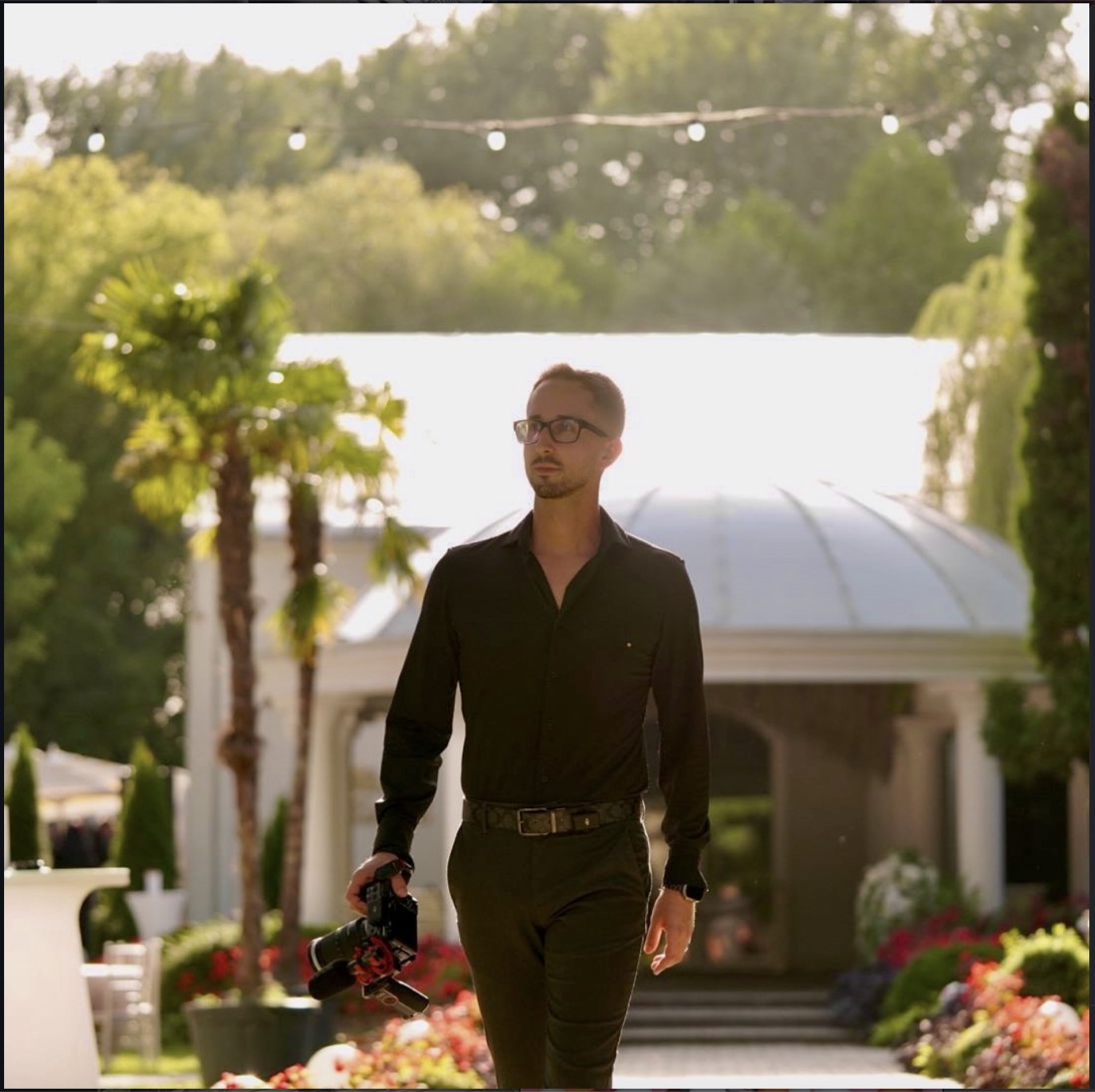 Videographer Ionuț Varodi walking with a cinema camera at an outdoor event venue